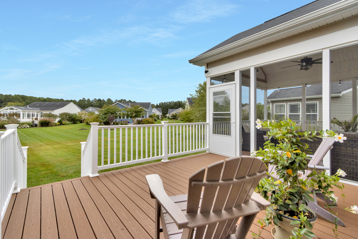Composite deck with Adirondack chairs and neighborhood view